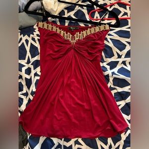 Beautiful crimson strapless Sky top, with gold detailing on the bust.